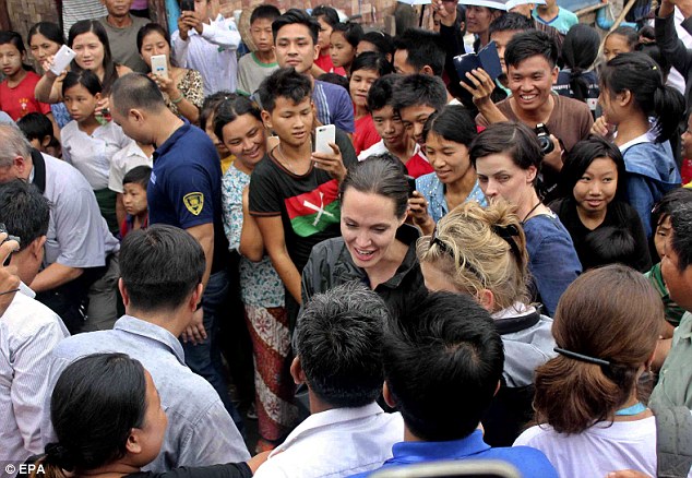 Welcome: Despite living a difficult life in incredible uncomfortable conditions, the refugees line the streets to give Angelina Jolie a warm welcome