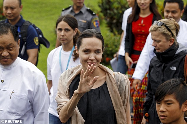 Friendly hello: UNHCR special envoy Angelina Jolie waves her hand to fans as she arrives at Myitkyina airport in Myitkyina capital city of Kachin state